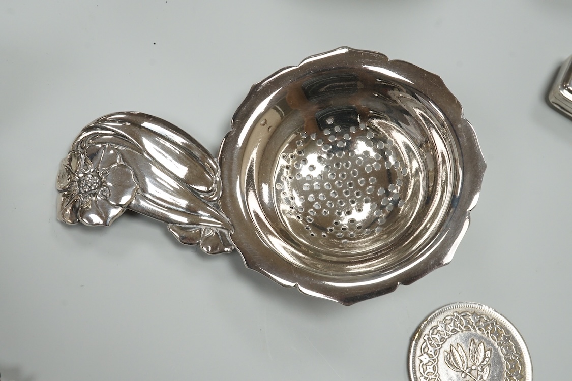 A late Victorian repousse silver navette shaped dish, by Charles Edwards, London, 1894, 25.7cm, with engraved monogram and date, together with a pair of mid 18th century silver sugar nips, an early 19th century silver vi